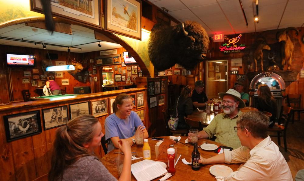 Friends sharing a meal in the steakhouse.
