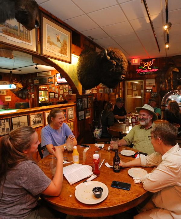Friends sharing a meal in the steakhouse.